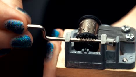 Detailed-view-of-the-insides-of-an-old-vintage-music-box-as-it-plays.-Slow-tracking-movements