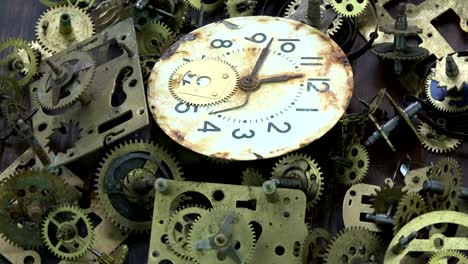 Vintage-analog-clock-brass-gears-and-cogs-with-rusty-dial-clock-face-rotating-background