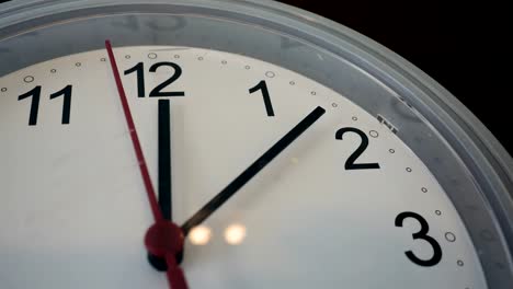 Wall-clock-with-twelve-oclock-and-a-red-ticking-arrow.-Professional-shot-in-4K-resolution