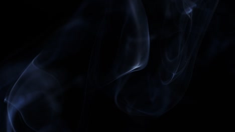 smoke-slowly-floating-through-space-against-black-background.