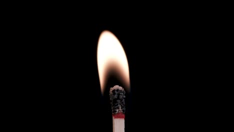 Macth-igniting-isolated-over-black-background