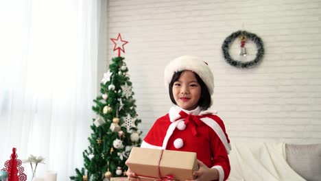 Santa-kid-holding-gifts-box-dancing.