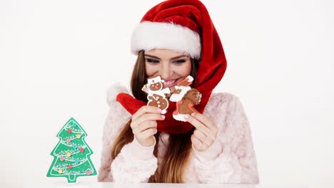 Woman-santa-claus-hat-with-gingerbread-cookies.-Christmas-4K