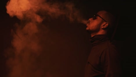 Stylish-Black-Man-Vaping-and-Exhaling-Smoke