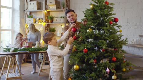 Niños-ayudando-a-los-padres-para-decorar-la-casa-para-Navidad