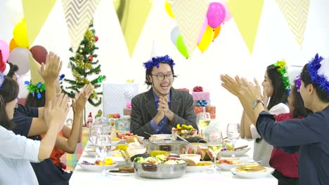 Group-of-asian-people-gathering-at-table-together-and-celebrating-Christmas-with-delicious-meal-at-new-year-party-together.-People-with-holidays-and-celebration-concept.