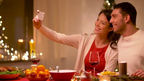 couple-taking-selfie-at-home-christmas-dinner