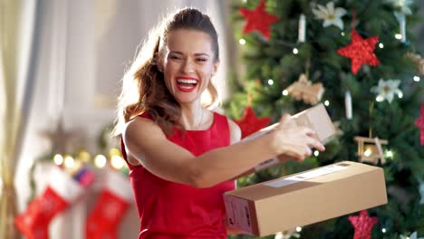 happy-trendy-housewife-with-parcels-near-Christmas-tree