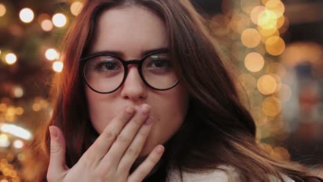 Girl-have-fun-near-Christmas-tree-and-smile-to-camera