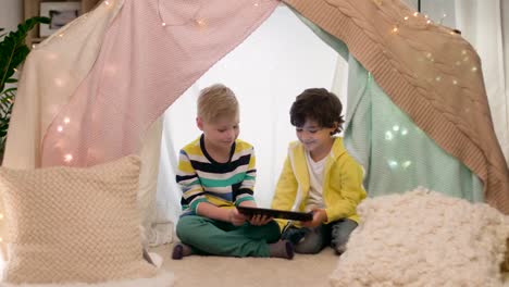 little-boys-with-tablet-pc-in-kids-tent-at-home