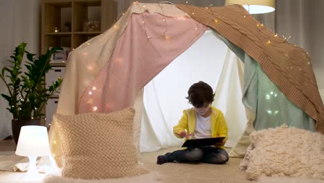 little-boy-with-tablet-pc-in-kids-tent-at-homea