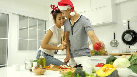 Couple-preparing-food-for-christmas-party-in-kitchen-at-home