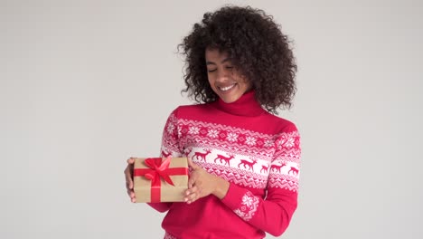 Happy-woman-holding-Christmas-gift