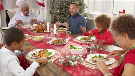 Family-With-Grandparents-Enjoying-Christmas-Meal-Shot-On-R3D