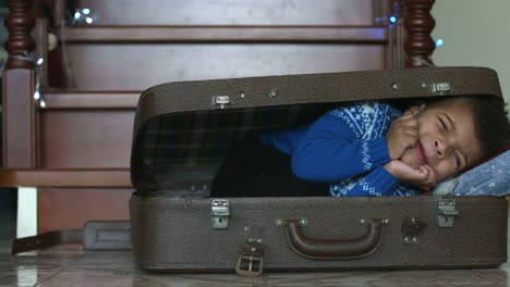 Boy-sleeping-in-suitcase.