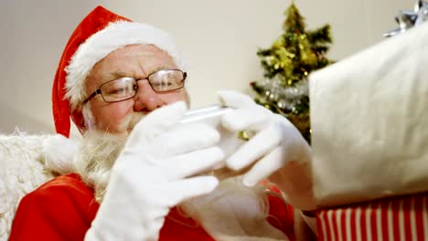 Santa-claus-holding-christmas-gift