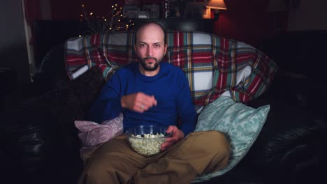 4k-Authentic-Shot-of-a-Funny-Man-Watching-Movie-and-Eating-Popcorn