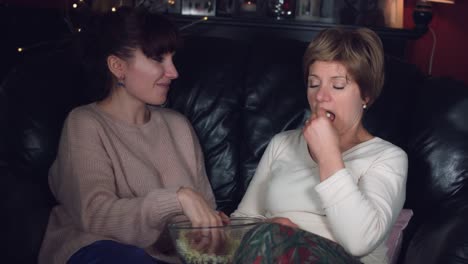 4k-Authentic-Shot-of-a-Girl-with-her-Mum-Talking-and-Eating-Popcorn