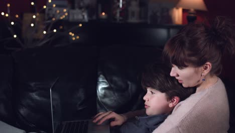 4k-Authentic-Shot-of-a-Child-with-his-Mum-Searching-on-Laptop