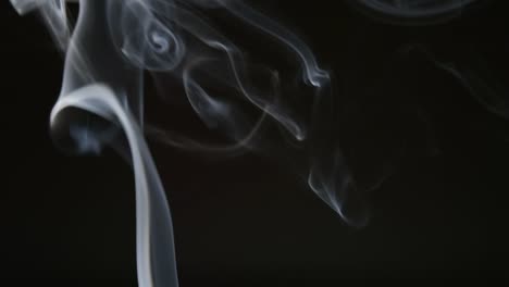 SLOW-MOTION:-Curly-line-of-smoke-on-a-dark-background