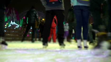 Concept-Closeup-Winter-Sport.-Crowd-at-Night-City-Skating-Rink-Pedestal-and-Blur