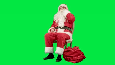 Santa-claus-calling-by-mobile-cell-phone-on-a-Green-Screen-Chrome-Key