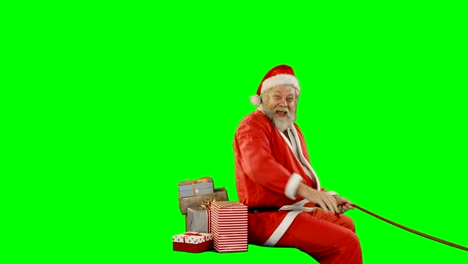 Santa-claus-with-gift-box-riding-on-green-screen