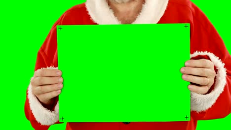 Mid-section-of-santa-claus-holding-blank-placard