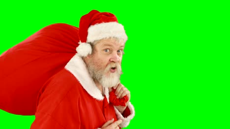 Santa-Claus-mit-Finger-auf-den-Lippen-tragen-sack