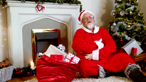 Santa-claus-sitting-fireplace-and-singing