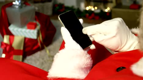 Close-up-of-santa-claus-using-mobile-phone