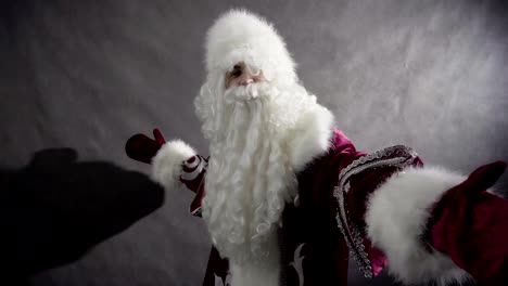 Cheerful-Santa-Claus-dancing-against-black-background