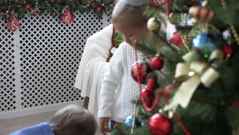 Little-boy-decorates-the-Christmas-tree.