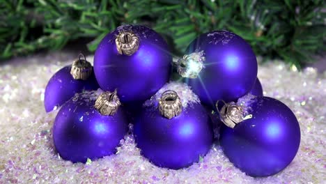 Snow-slowly-falls-on-New-Year's-balls-against-the-background-of-a-Christmas-fir-tree