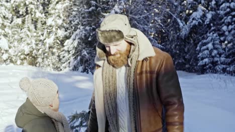 Parents-and-Boy-Carrying-Christmas-Tree-Home