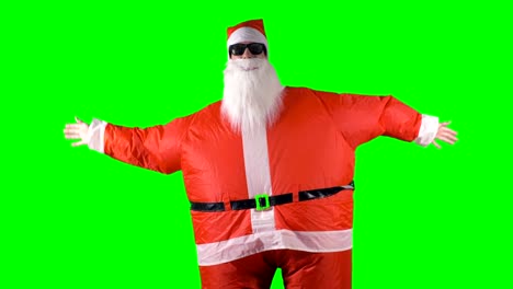 Santa-Claus-macht-Arm-Welle-tanzen-bewegt-sich-auf-einem-grünen-Hintergrund.