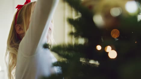 Young-Girl-Decorating-Christmas-Tree