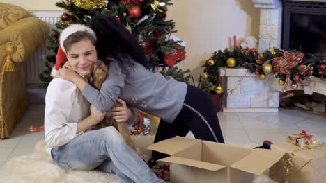 Happy-in-love-couple-with-their-dog-near-Christmas-tree