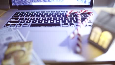 Opened-laptop-with-blinking-candles-on-table