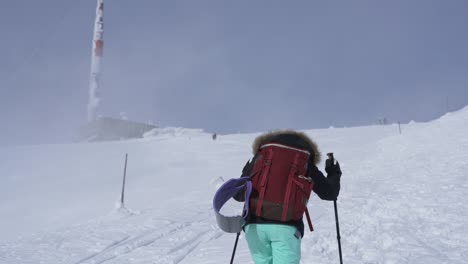 Girl-hiking-on-snow-in-Slovak-mountains-during-sunny-day-in-winter