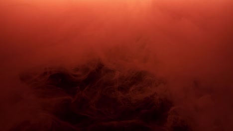 Red-ink-spraying-in-water-on-black-background.