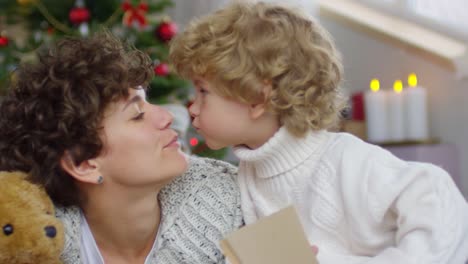 Adorable-Boy-Kissing-Mother-on-Christmas-Day