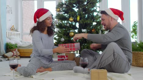 Man-Receiving-Christmas-Present-from-Woman