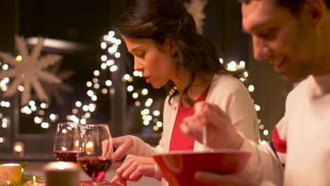 happy-couple-eating-at-christmas-dinner