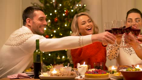 Glückliche-Freunde-trinken-Rotwein-zu-Weihnachten