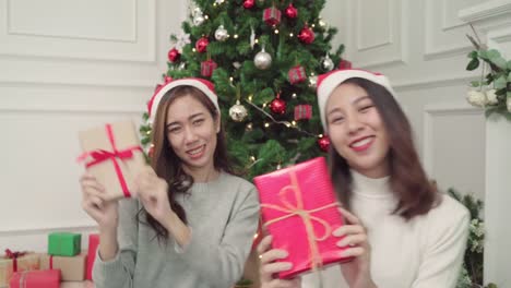 Gruppe-von-fröhlich-glücklich-junge-asiatische-Frauen-Weihnachten-Geschenke-miteinander-in-ihrem-Wohnzimmer-zu-Hause-in-Christmas-Festival.-Lifestyle-Frauen-feiern-Weihnachten-und-Neujahr-Konzept.