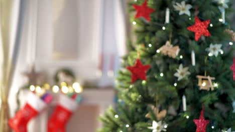 smiling-modern-housewife-with-parcels-near-Christmas-tree