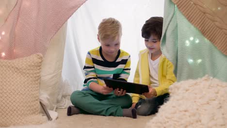 little-boys-with-tablet-pc-in-kids-tent-at-home