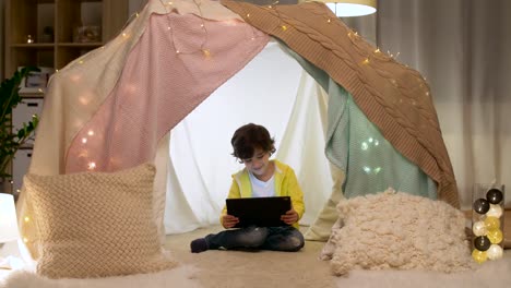 little-boy-with-tablet-pc-in-kids-tent-at-homea