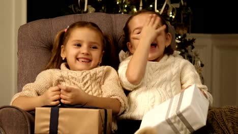 Girls-play-hiding-game-closing-their-faces-with-hands.-Christmas-kids,child,-portrait